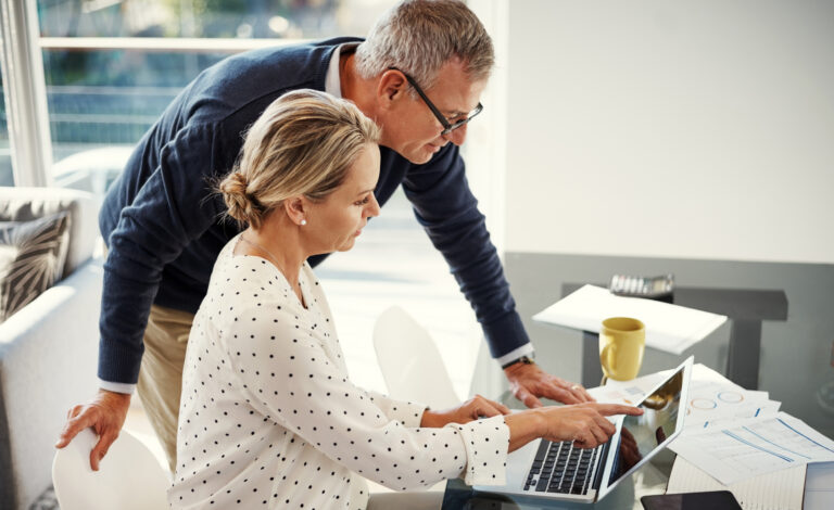 Mature,Couple,,Laptop,And,Talking,With,Point,For,Financial,Planning,